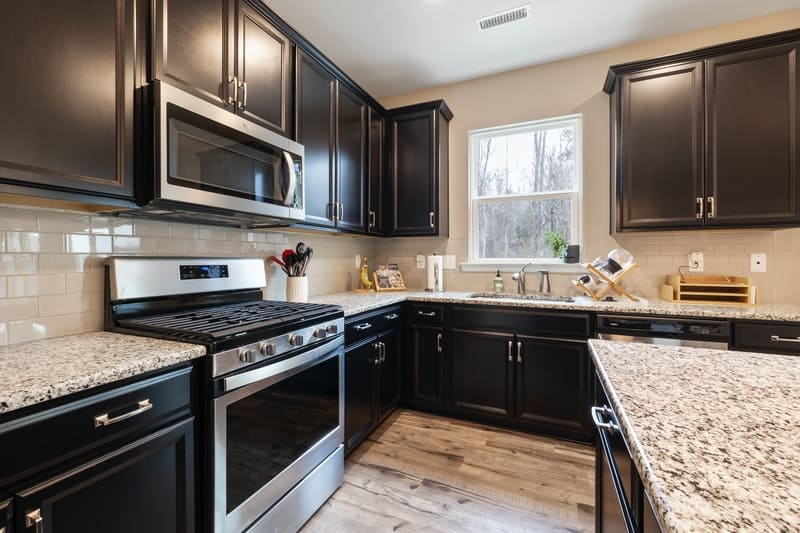 Dark cabinets with dark outlet granite